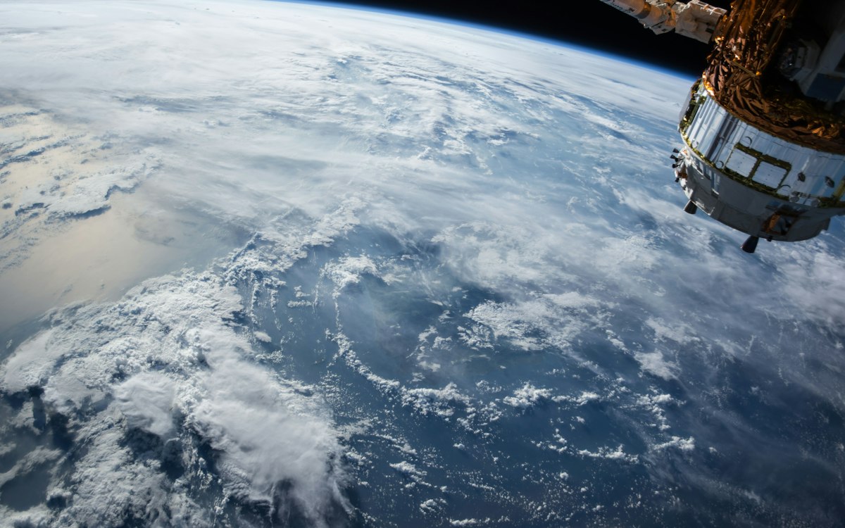 A view of Earth and a spacecraft from orbit.